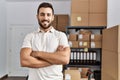 Young hispanic man smiling confident standing with arms crossed gesture at storehouse Royalty Free Stock Photo
