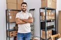 Young hispanic man smiling confident standing with arms crossed gesture at storehouse Royalty Free Stock Photo