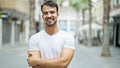 Young hispanic man smiling confident standing with arms crossed gesture at street Royalty Free Stock Photo