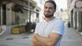 Young hispanic man smiling confident standing with arms crossed gesture at street Royalty Free Stock Photo