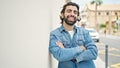 Young hispanic man smiling confident standing with arms crossed gesture at street Royalty Free Stock Photo