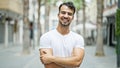 Young hispanic man smiling confident standing with arms crossed gesture at street Royalty Free Stock Photo