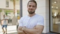 Young hispanic man smiling confident standing with arms crossed gesture at street Royalty Free Stock Photo