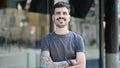 Young hispanic man smiling confident standing with arms crossed gesture at street Royalty Free Stock Photo