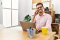 Young hispanic man smiling confident talking on the smartphone at office Royalty Free Stock Photo