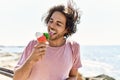 Young hispanic man smiling happy eating ice cream at the beach Royalty Free Stock Photo