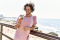 Young hispanic man smiling happy eating ice cream at the beach Royalty Free Stock Photo