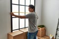Young hispanic man smiling happy moving at new home Royalty Free Stock Photo