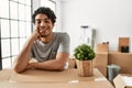 Young hispanic man smiling happy moving at new home Royalty Free Stock Photo