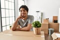 Young hispanic man smiling happy moving at new home Royalty Free Stock Photo