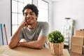 Young hispanic man smiling happy moving at new home Royalty Free Stock Photo