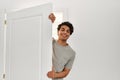 Young hispanic man smiling happy opening door of new home