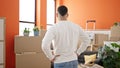 Young hispanic man standing on back view at new home Royalty Free Stock Photo