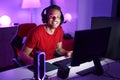 Young hispanic man streamer playing video game using computer at gaming room Royalty Free Stock Photo