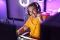 Young hispanic man streamer playing video game using computer at gaming room Royalty Free Stock Photo