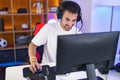 Young hispanic man streamer playing video game using computer at gaming room Royalty Free Stock Photo