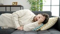 Young hispanic man suffering for headache lying on sofa at home Royalty Free Stock Photo
