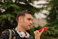 A young Hispanic man talking on his smartphone, on a street outdoors. lifestyle concept Royalty Free Stock Photo