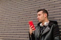 A young Hispanic man talking on his smartphone, on a street outdoors. lifestyle concept Royalty Free Stock Photo