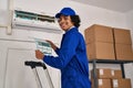 Young hispanic man technician repairing air conditioning at office Royalty Free Stock Photo