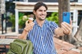 Young hispanic man tourist making selfie by smartphone eating ice cream at park Royalty Free Stock Photo