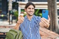 Young hispanic man tourist making selfie by smartphone eating ice cream at park Royalty Free Stock Photo