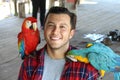 Young Hispanic man with two `guacamayas` Royalty Free Stock Photo