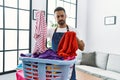 Young hispanic man unhappy doing chores at home Royalty Free Stock Photo