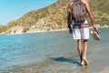 Young Hispanic man walking barefoot on a deserted beach Royalty Free Stock Photo