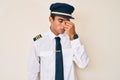 Young hispanic man wearing airplane pilot uniform tired rubbing nose and eyes feeling fatigue and headache Royalty Free Stock Photo