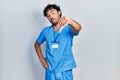 Young hispanic man wearing blue male nurse uniform looking unhappy and angry showing rejection and negative with thumbs down Royalty Free Stock Photo
