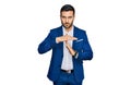 Young hispanic man wearing business jacket doing time out gesture with hands, frustrated and serious face Royalty Free Stock Photo