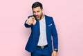 Young hispanic man wearing business jacket pointing displeased and frustrated to the camera, angry and furious with you Royalty Free Stock Photo