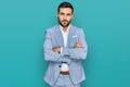 Young hispanic man wearing business jacket skeptic and nervous, disapproving expression on face with crossed arms Royalty Free Stock Photo