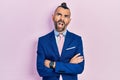 Young hispanic man wearing business suit with arms crossed gesture angry and mad screaming frustrated and furious, shouting with Royalty Free Stock Photo