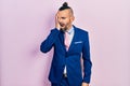 Young hispanic man wearing business suit and tie yawning tired covering half face, eye and mouth with hand Royalty Free Stock Photo