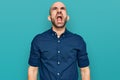 Young hispanic man wearing casual clothes angry and mad screaming frustrated and furious, shouting with anger Royalty Free Stock Photo