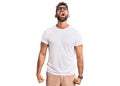 Young hispanic man wearing casual clothes and glasses angry and mad screaming frustrated and furious, shouting with anger Royalty Free Stock Photo