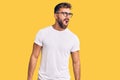 Young hispanic man wearing casual clothes and glasses angry and mad screaming frustrated and furious, shouting with anger Royalty Free Stock Photo