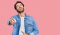 Young hispanic man wearing casual clothes laughing at you, pointing finger to the camera with hand over body, shame expression Royalty Free Stock Photo