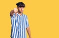 Young hispanic man wearing casual clothes looking unhappy and angry showing rejection and negative with thumbs down gesture Royalty Free Stock Photo