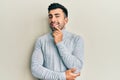 Young hispanic man wearing casual clothes smiling looking confident at the camera with crossed arms and hand on chin Royalty Free Stock Photo