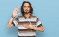 Young hispanic man wearing casual clothes swearing with hand on chest and open palm, making a loyalty promise oath Royalty Free Stock Photo