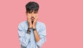 Young hispanic man wearing casual clothes tired hands covering face, depression and sadness, upset and irritated for problem Royalty Free Stock Photo