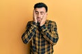 Young hispanic man wearing casual clothes tired hands covering face, depression and sadness, upset and irritated for problem Royalty Free Stock Photo