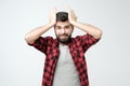 Young hispanic man is surprised with hand on head for mistake, remember error Royalty Free Stock Photo