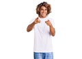 Young hispanic man wearing casual white tshirt pointing fingers to camera with happy and funny face Royalty Free Stock Photo