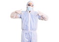 Young hispanic man wearing doctor protection coronavirus uniform and medical mask looking confident with smile on face, pointing Royalty Free Stock Photo