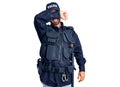 Young hispanic man wearing police uniform covering eyes with arm smiling cheerful and funny Royalty Free Stock Photo