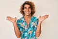 Young hispanic man wearing summer shirt celebrating victory with happy smile and winner expression with raised hands Royalty Free Stock Photo